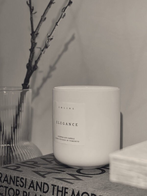 emline home_elegance soy candle_on top of book